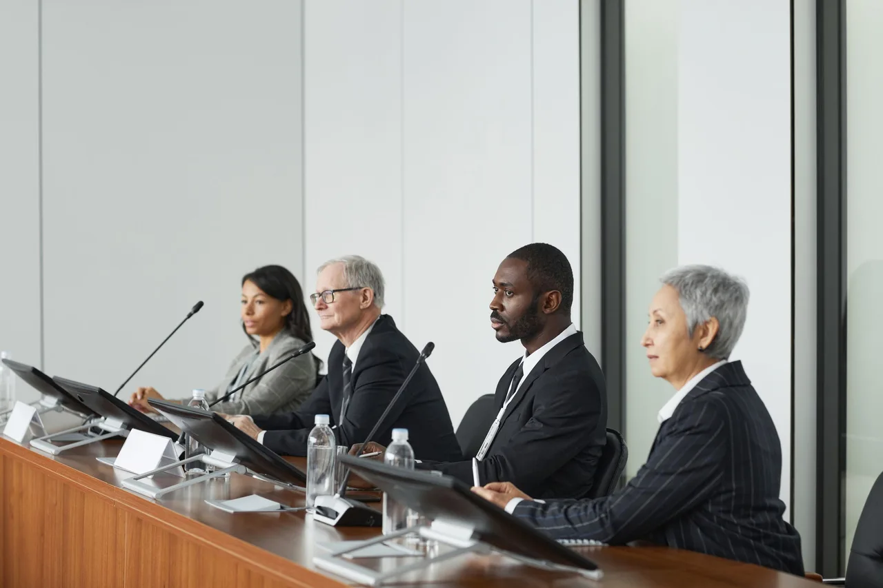 Senior delegates in discussion on a conference panel