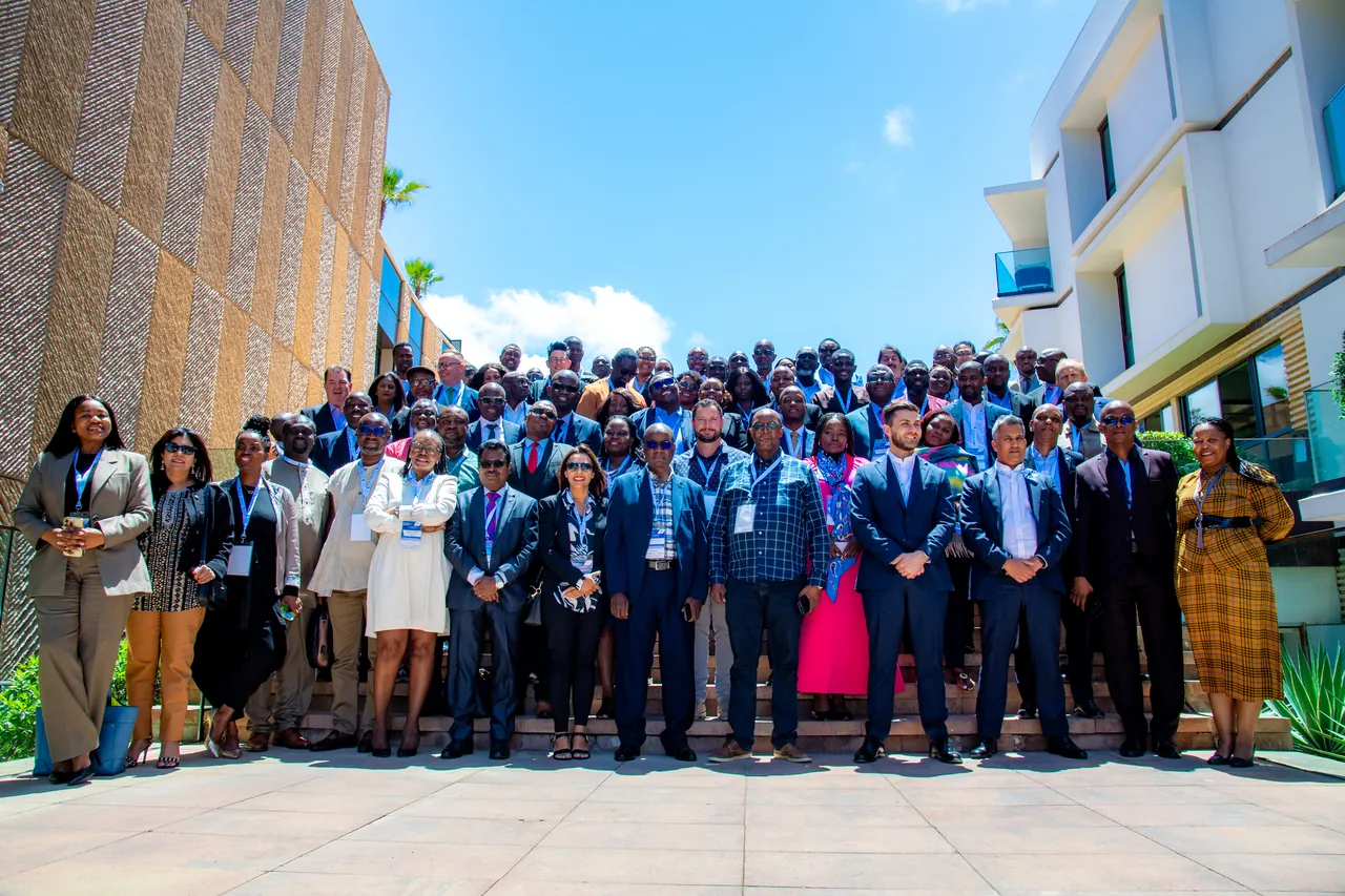 The delegation photographed outdoors at the 2025 summit
